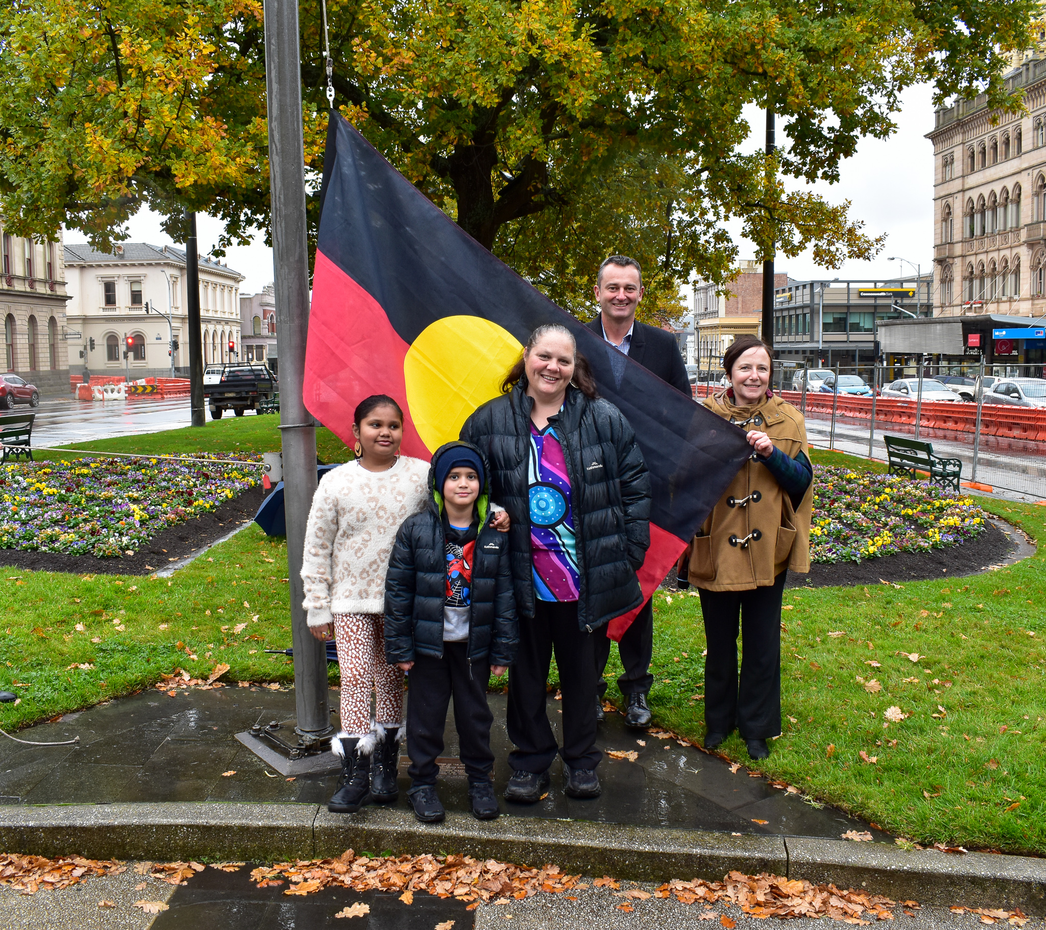 People holding aboriginal flag 