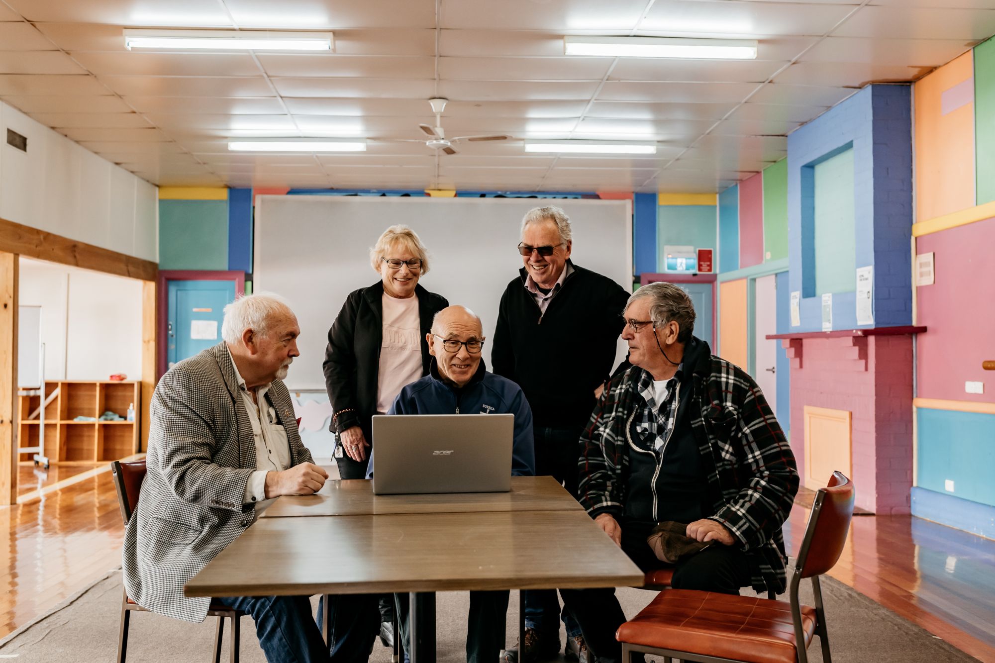 Group of community members around a computer
