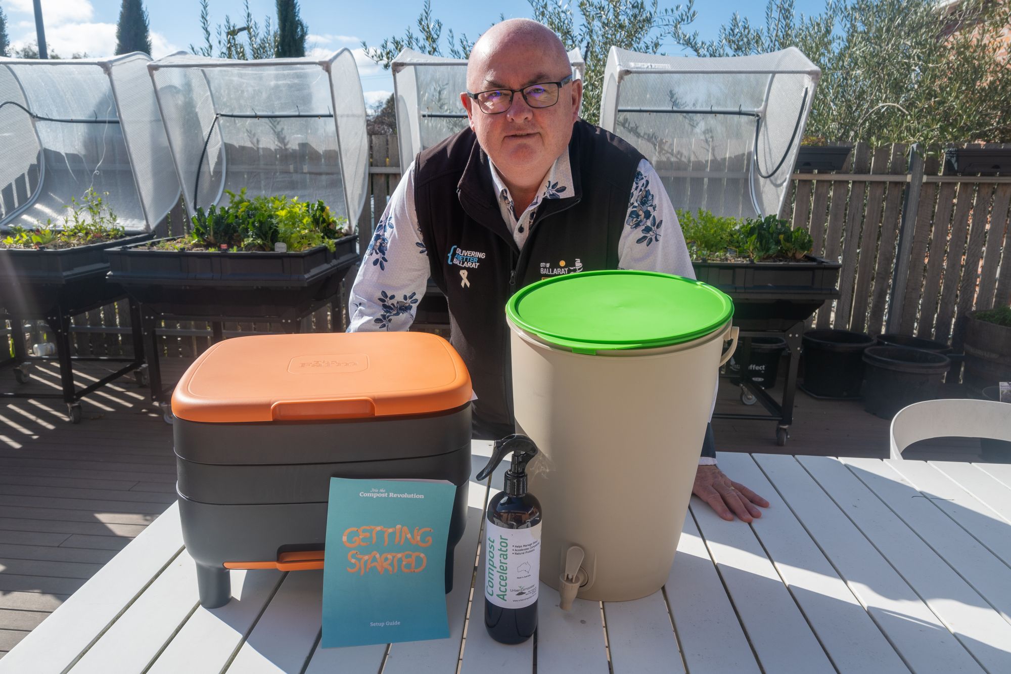 City of Ballarat Mayor Cr Des Hudson with a Compost Revolution worm farm and bokashi bin.