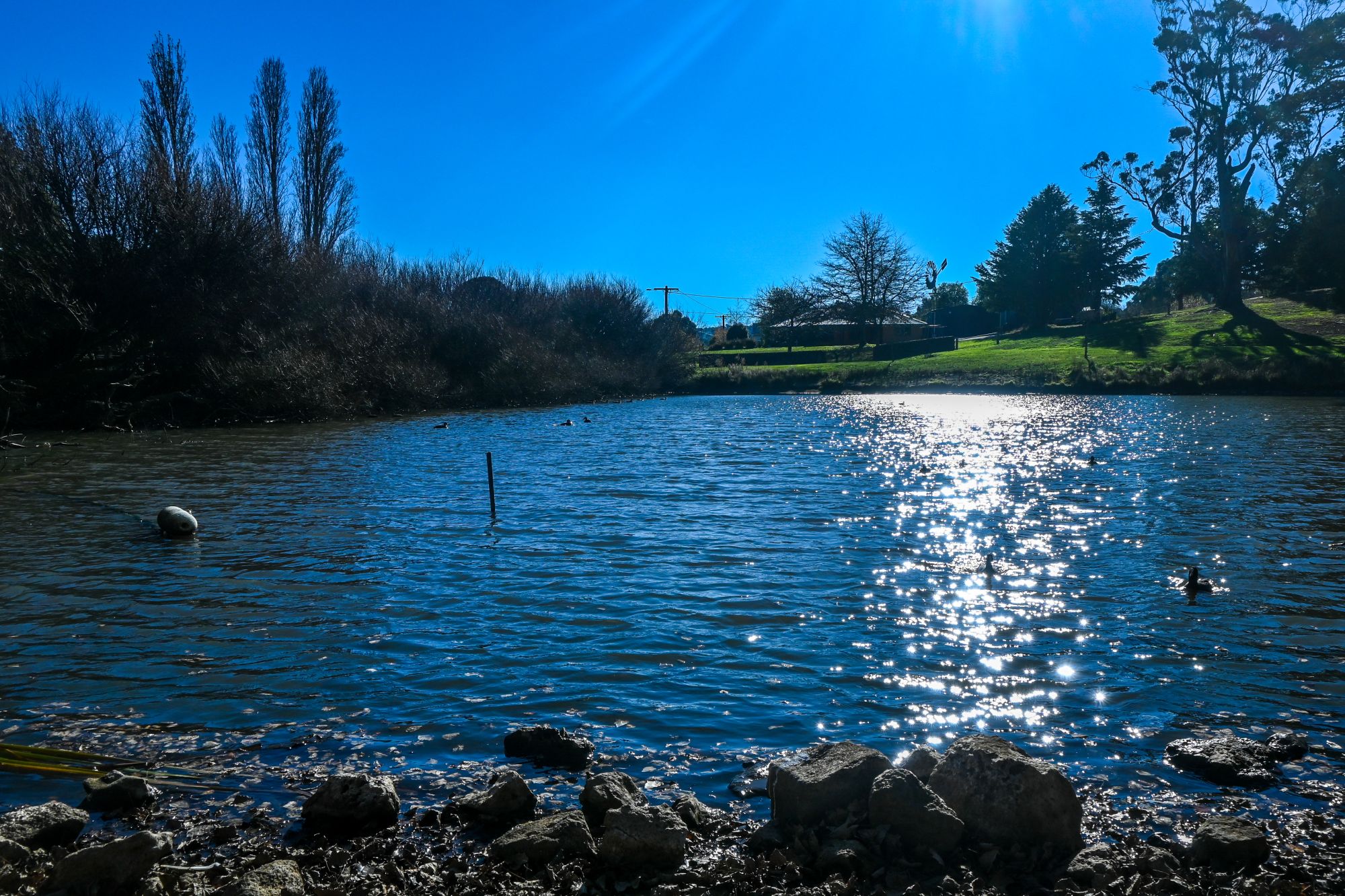 Photo of Gong Dam in Buninyong, sparking water in foreground and bright sky