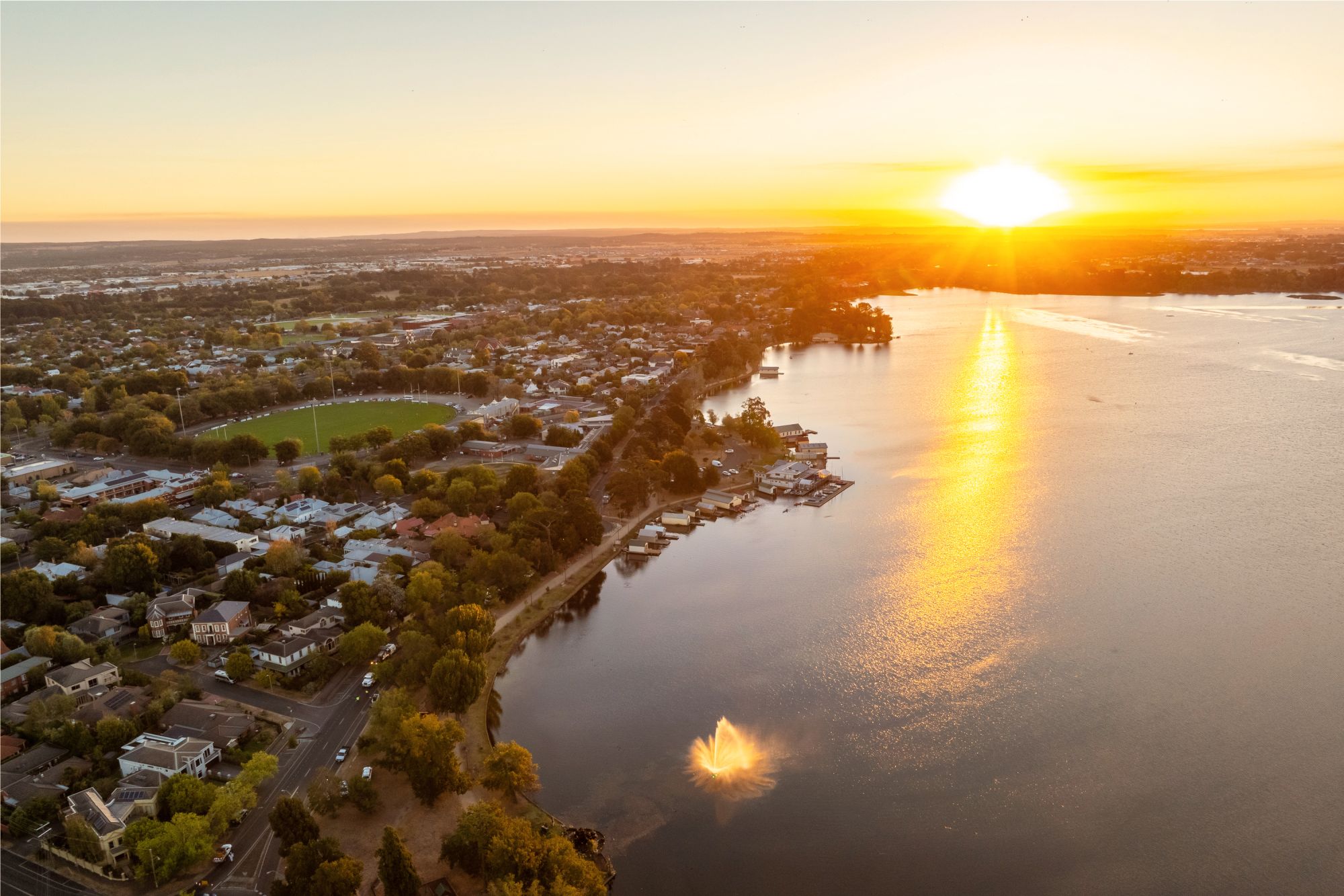 Aerial view of Lake Wendouree at sunset with fountain and City Oval.