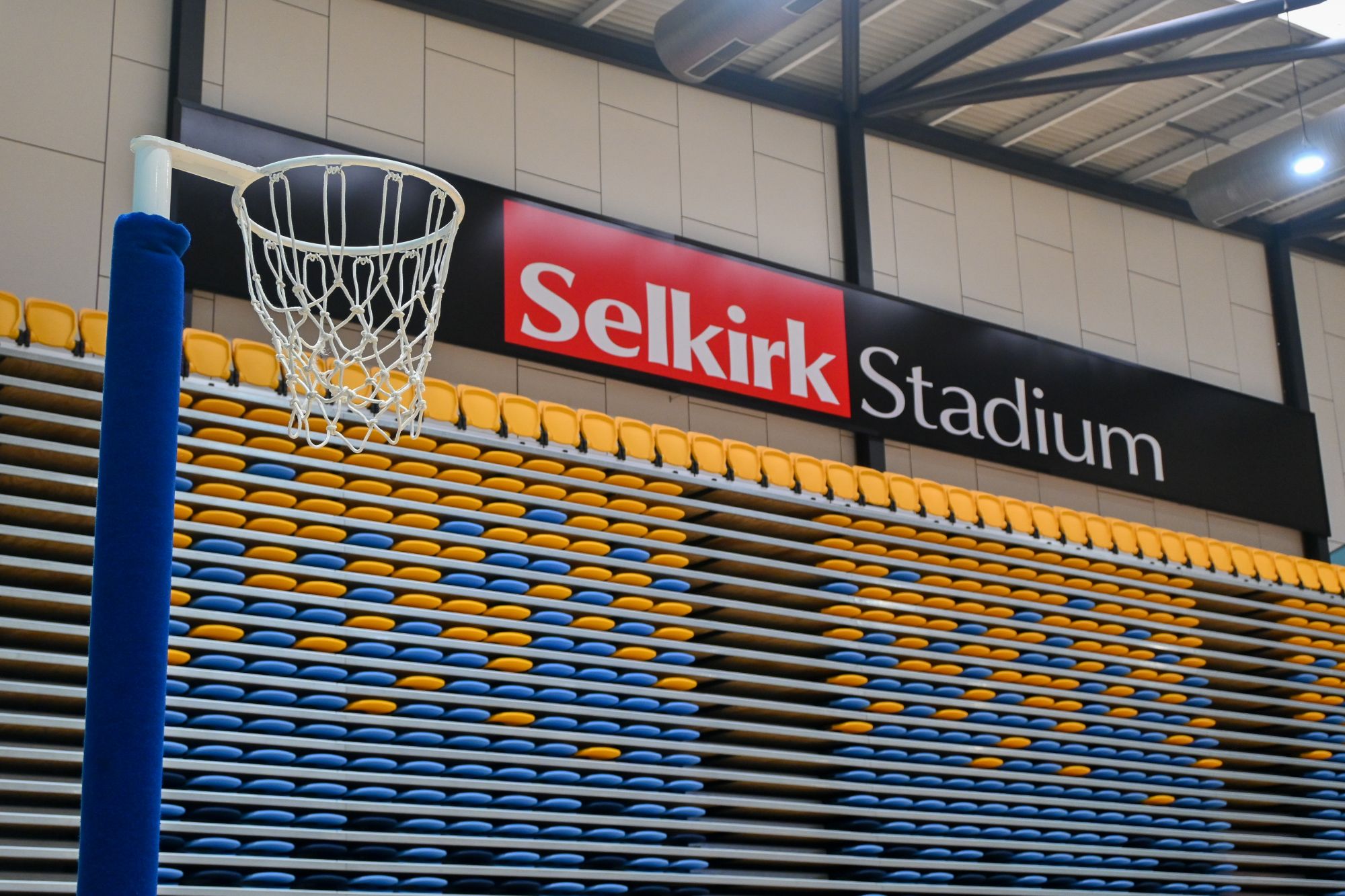 Sign of Selkirk Stadium with netball ring and seating