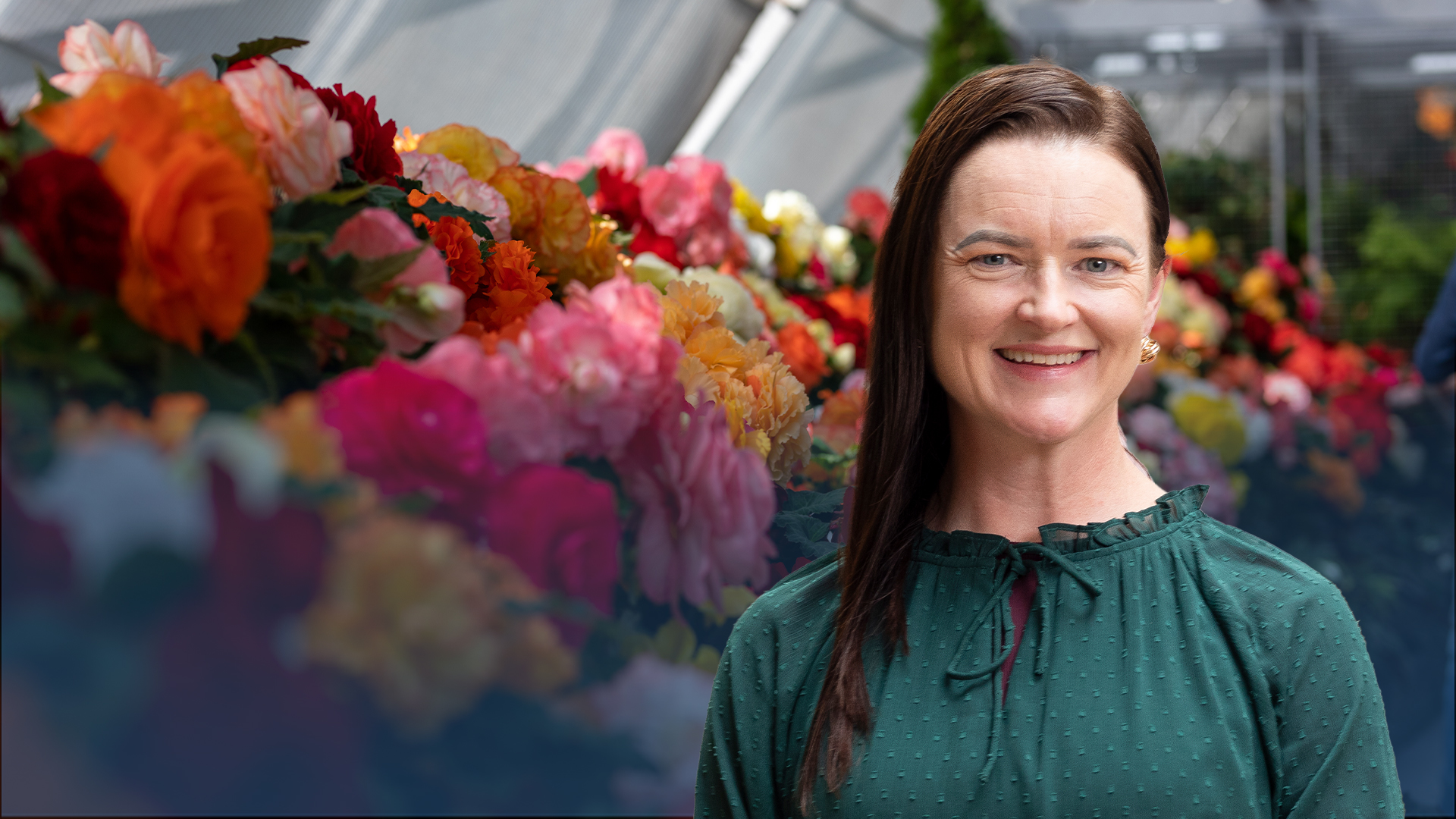 Image of Mayor Cr Tracey Hargreaves in front of a begonia flower display