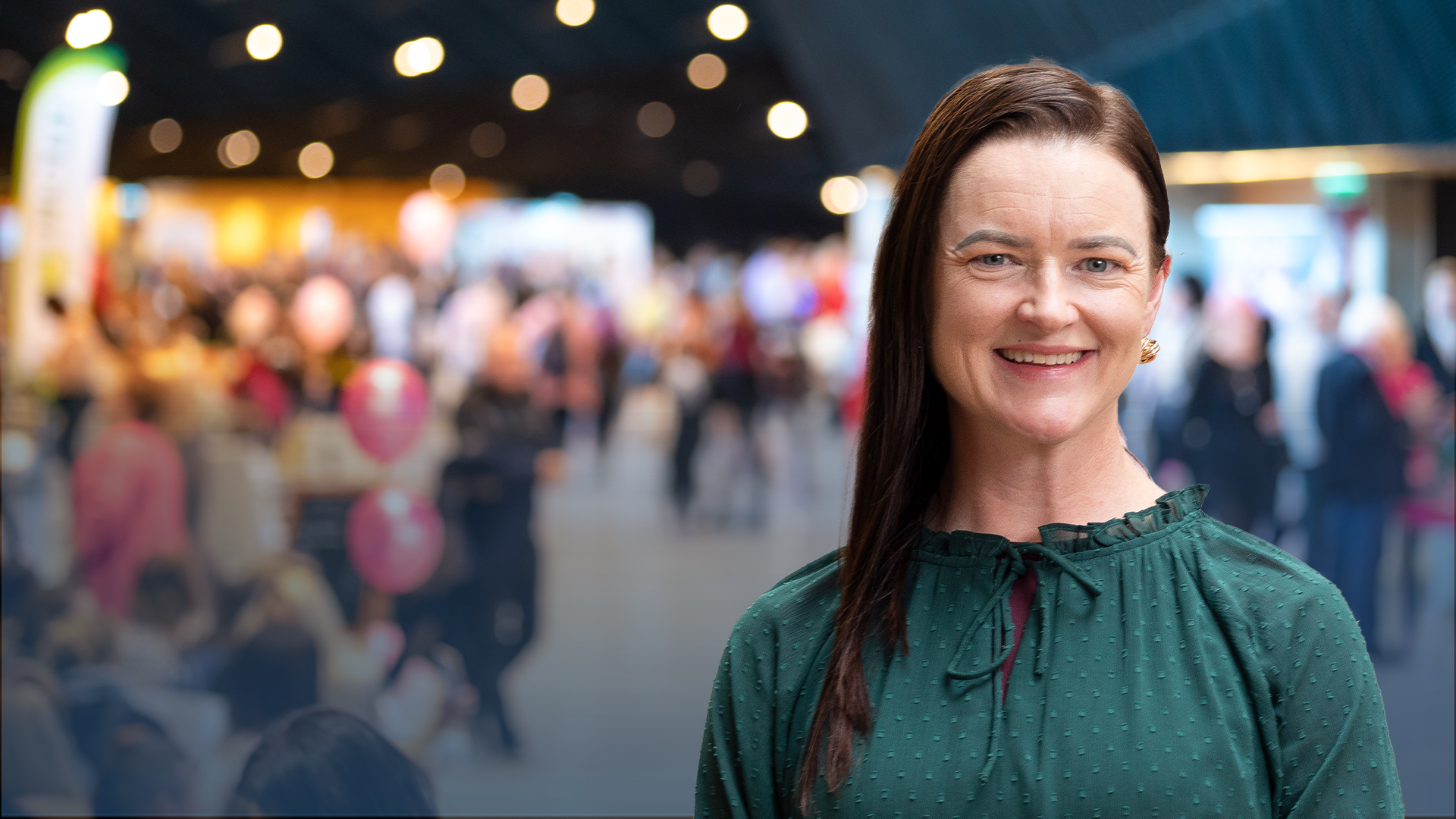 Image of Mayor Cr Tracey Hargreaves in front of a blurred image of an expo