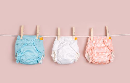 cloth reusable nappies hanging on a clothes line 