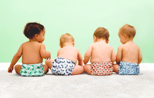 four babies wearing reusable modern cloth nappies