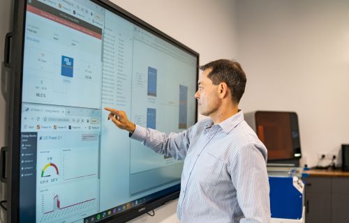 Generic photo of person using a smart board for work in an office