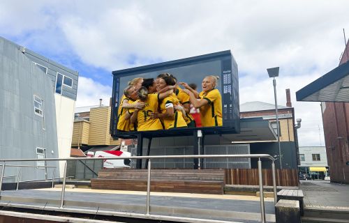 An altered image depicting the Matildas on the Alfred Deakin Place big screen.