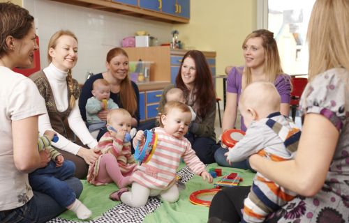 Group of mothers playing with babies