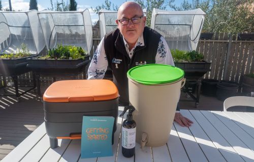 City of Ballarat Mayor Cr Des Hudson with a Compost Revolution worm farm and bokashi bin.