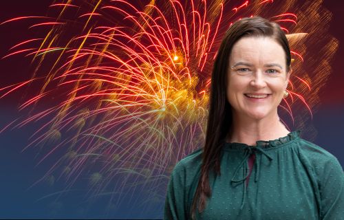 Portrait of Mayor Cr Tracey Hargreaves in front of an image of Ballarat's Fireworks display