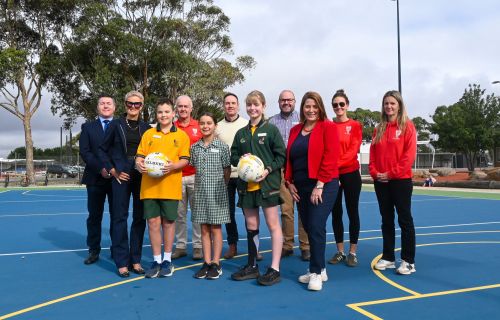 City of Ballarat Cr Damon Saunders and Member for Wendouree Juliana Addison with users of the newly developed Alfredton Primary School netball courts.