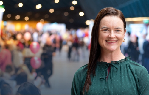 Image of Mayor Cr Tracey Hargreaves in front of a blurred image of an expo