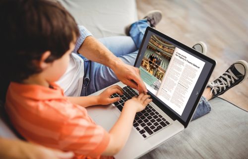 young child on laptop with adult reading the online ourballarat