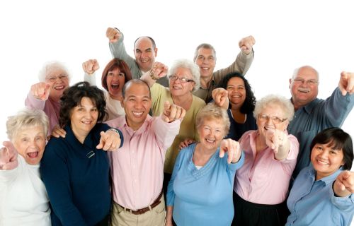 large group of seniors with arms in the air