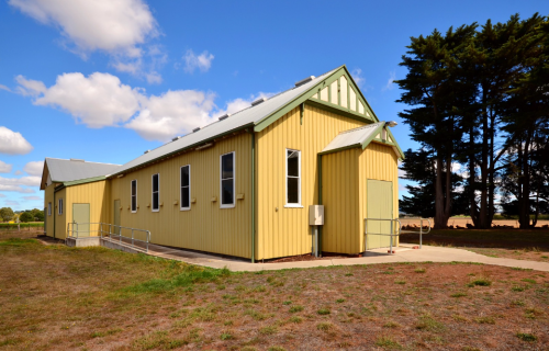 Image of the yellow and green Ascot Mutual Improvement Association Hall