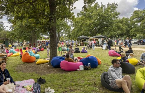 picnic in the park crowd in 2024 sitting on bean bags