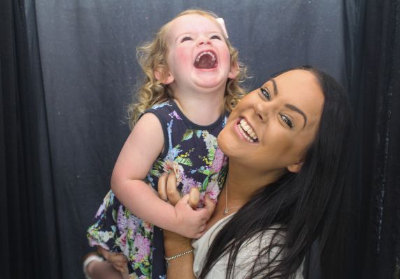 Woman holding Child laughing