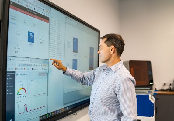 Generic photo of person using a smart board for work in an office