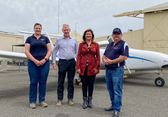 Generic photo group of people in front of an airplane 