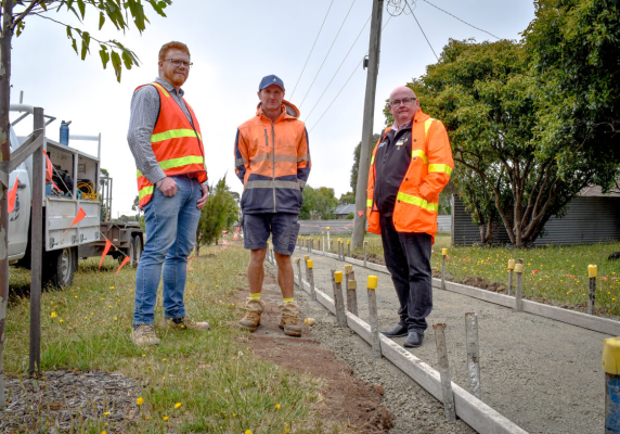 Mayor Cr Des Hudson with staff at the site of a footpath under construction