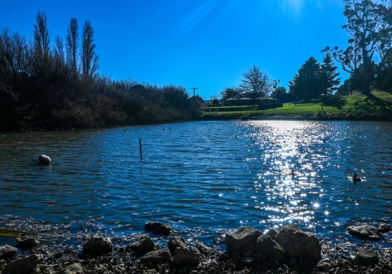 Photo of Gong Dam in Buninyong, sparking water in foreground and bright sky