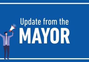 Update from the Mayor graphic tile, including image of person with megaphone