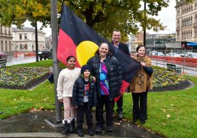 People holding aboriginal flag 
