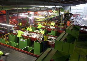 Works sorting rubbish in a Materials Recovery Facility