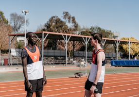 two young men on an athletics running track