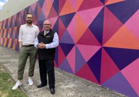 Generic image of Spencer Harrison and Mr Mayor in front of a colourful wall