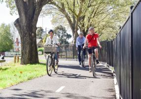 Generic image of Cr Coates, Evan King and Wallace Martin riding bikes on shared path