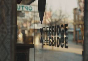 Close-up photo of a "heart the bridge" logo on a shop window